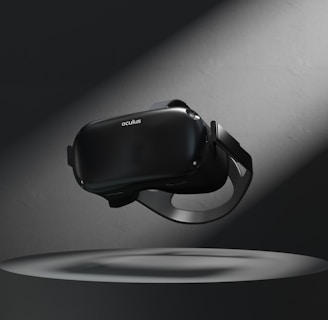 A virtual reality headset floating above a circular platform is illuminated by a spotlight. The surrounding area is dark, highlighting the sleek design of the device.