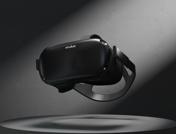 A virtual reality headset floating above a circular platform is illuminated by a spotlight. The surrounding area is dark, highlighting the sleek design of the device.
